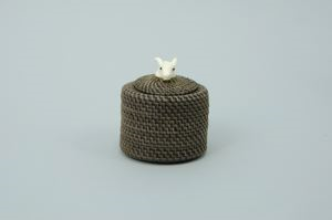 Image: small white-on-black baleen basket with ivory ram's head finial;